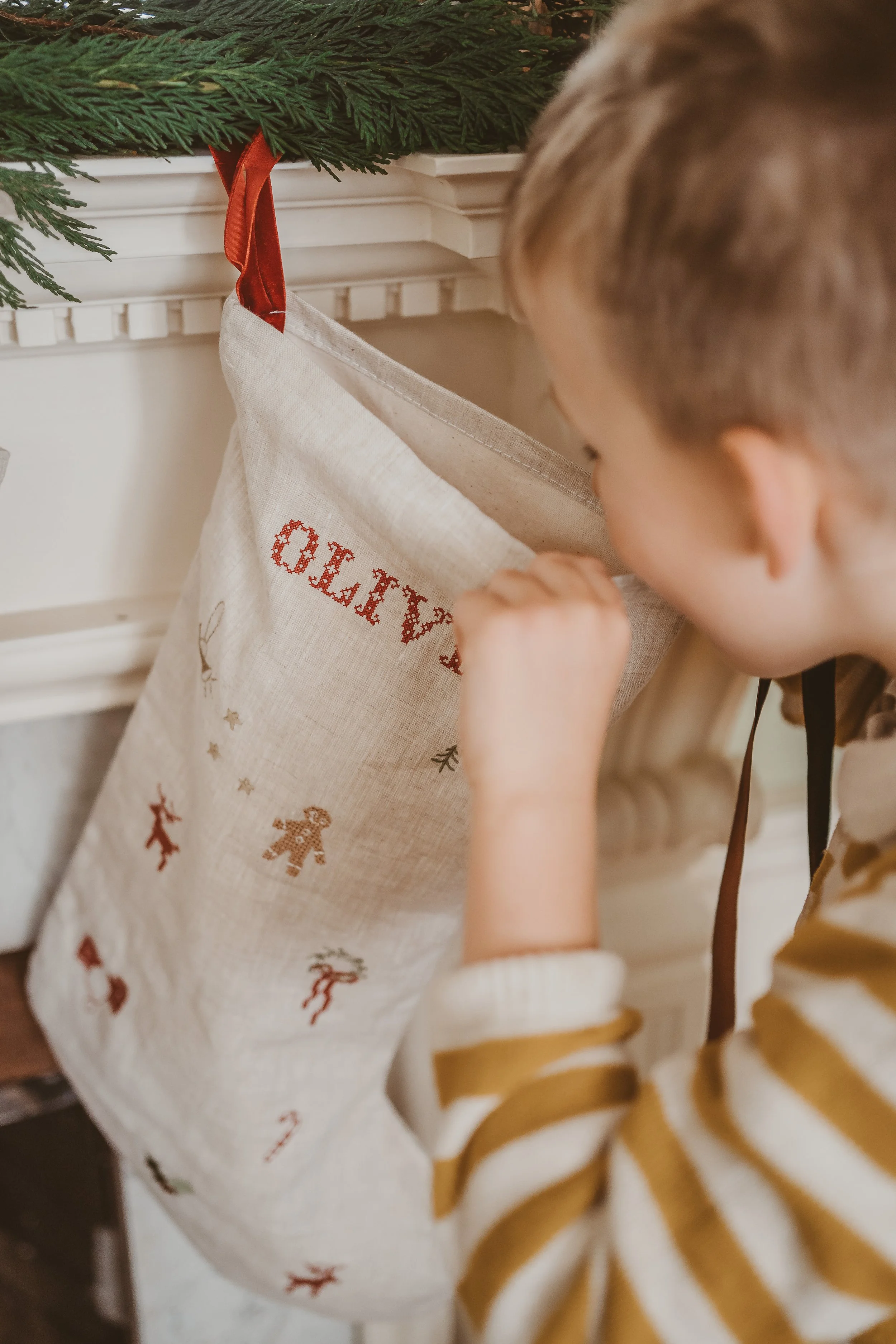 Boy looking into a stocking- product photo