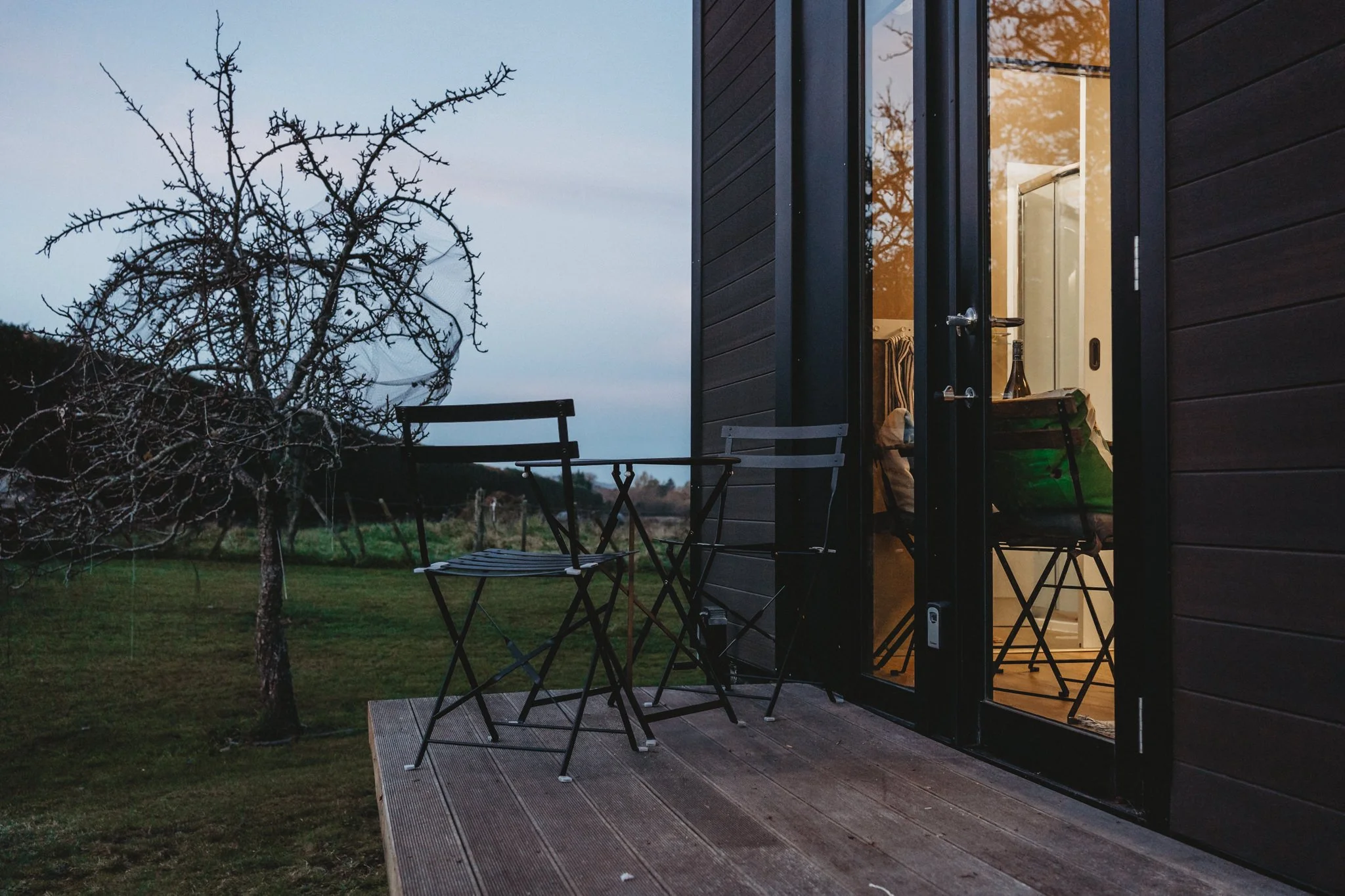 Cozy exterior shot of table and chairs.