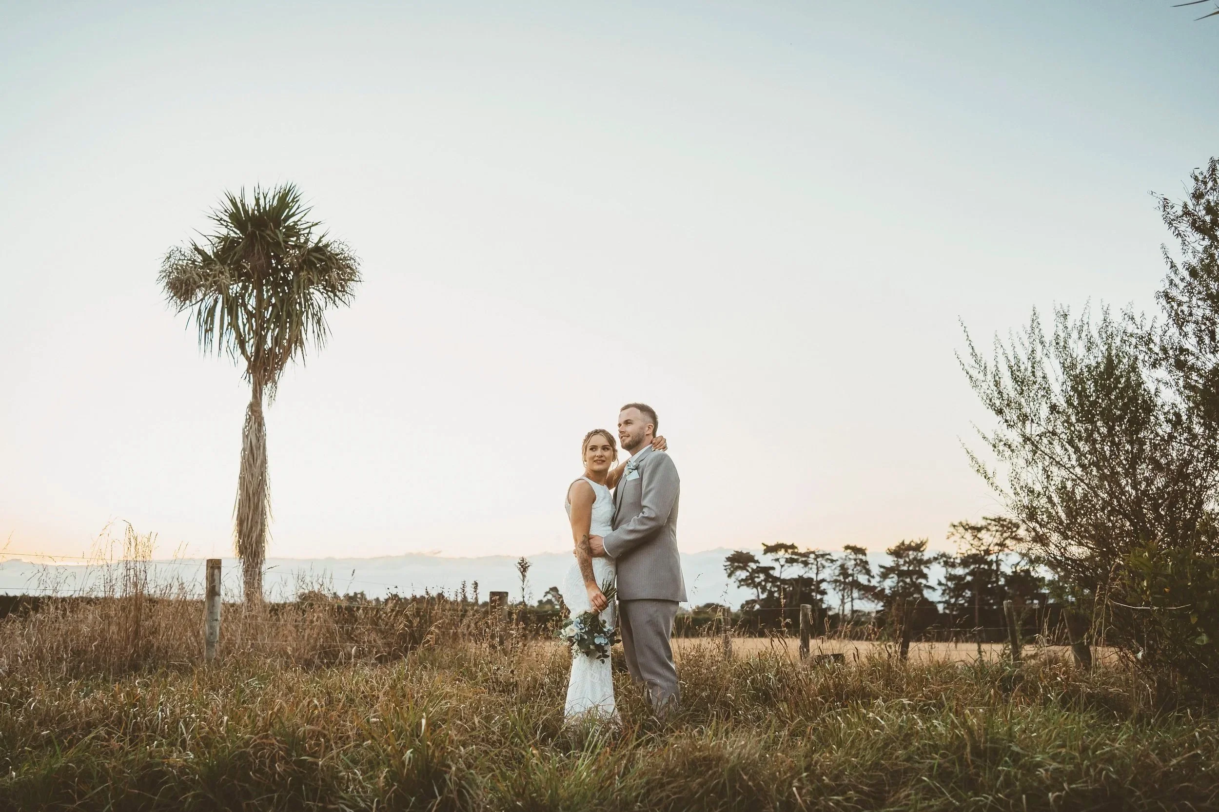 Newly married couple soaking in the sunset