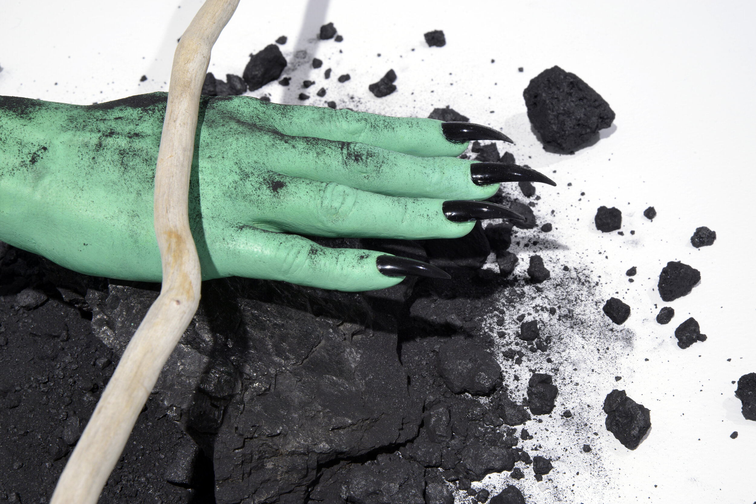  Alana Bartol,  Coal Futures (detail) , 2021, Hydrostone, acrylic paint, false nails, nail polish, coal, petroleum coke, core sample, dowsing rods.  