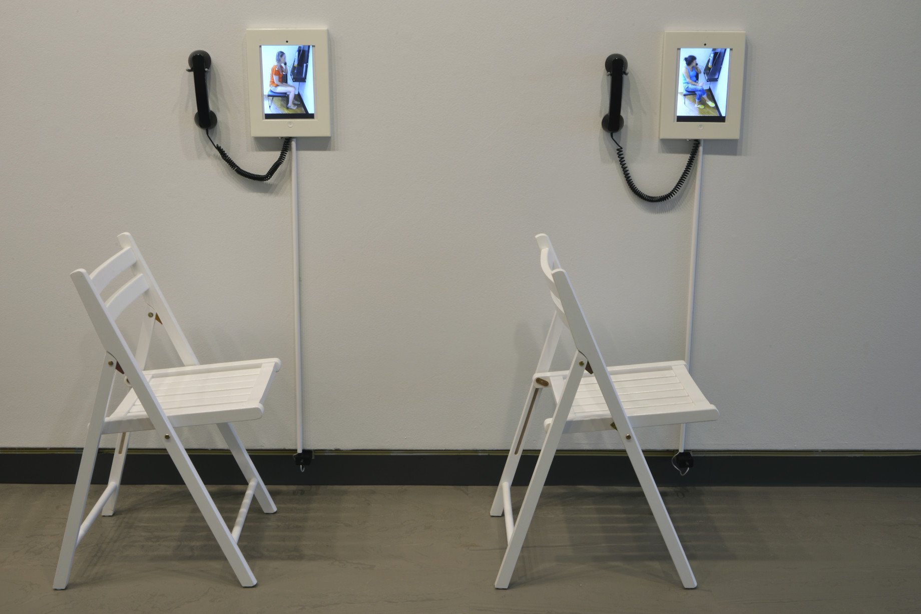   Here I Am (Bless My Mouth),  detail, 2013, multimedia installation, 10 Acer Tablets in holders with handheld telephone receivers and panorama. 