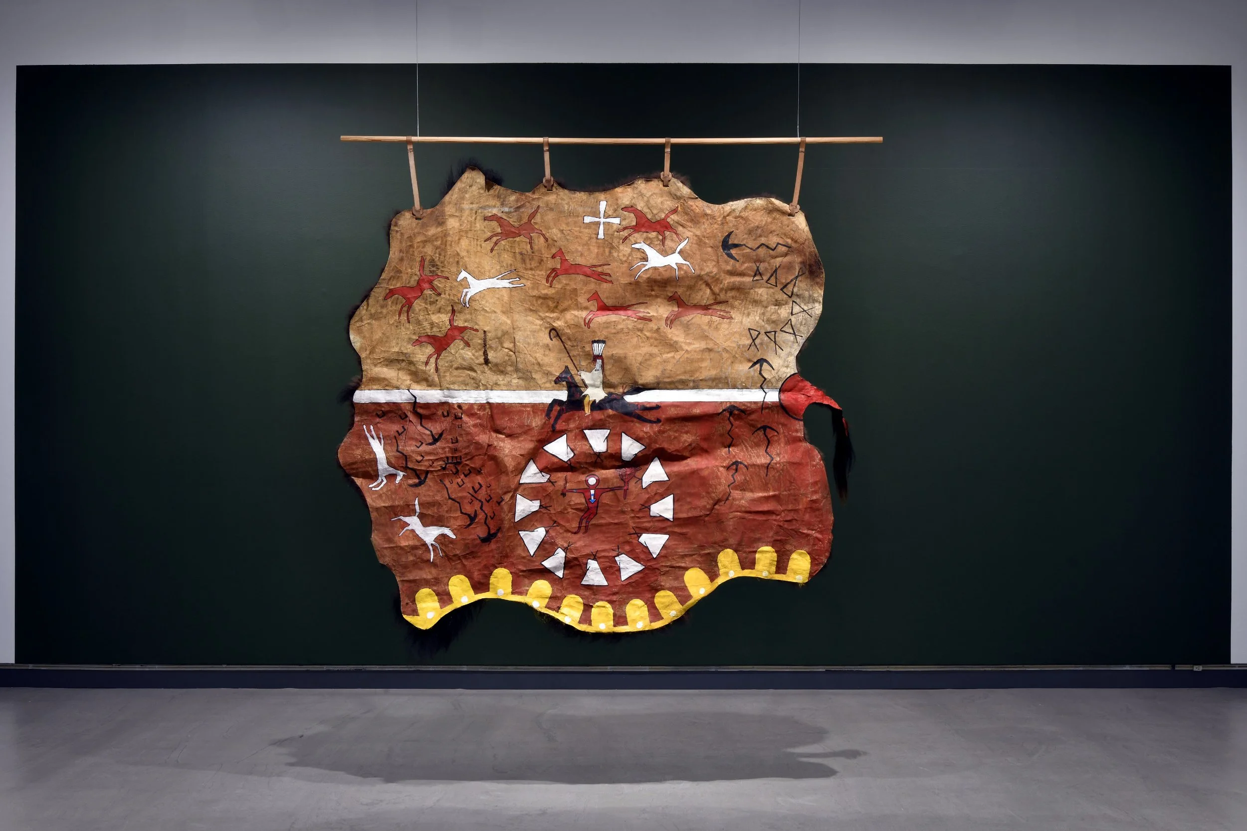  Kiitokii,  Captured Wealth , 2026, bison hide, ochre, charcoal, acrylic paint. 