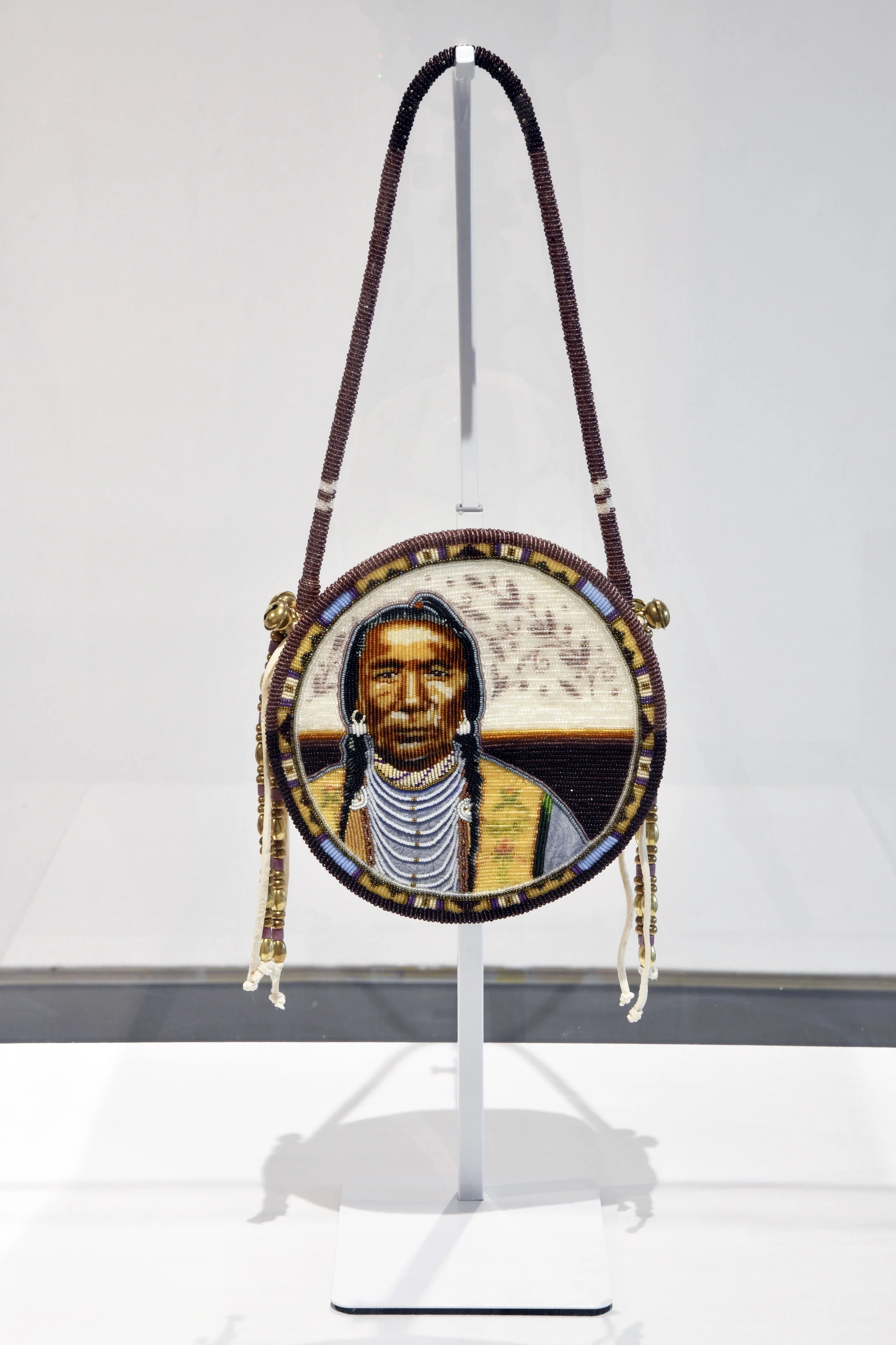  Jackie Larson Bread,  The Beauty That Surrounds Us , 2026, seed and cut glass beads, tanned buckskin, brass bells, beads, cotton. 