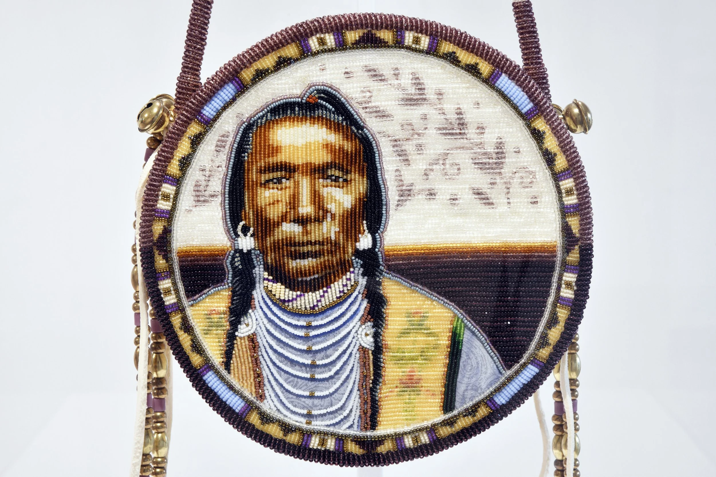  Jackie Larson Bread,  The Beauty That Surrounds Us  (detail), 2026, seed and cut glass beads, tanned buckskin, brass bells, beads, cotton. 