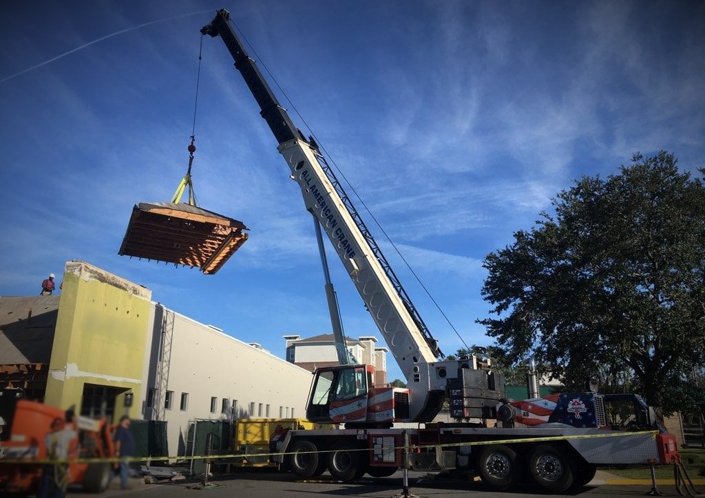70 Ton hydraulic mobile crane setting roof for roof work on commercial building in Tallahassee Florida.