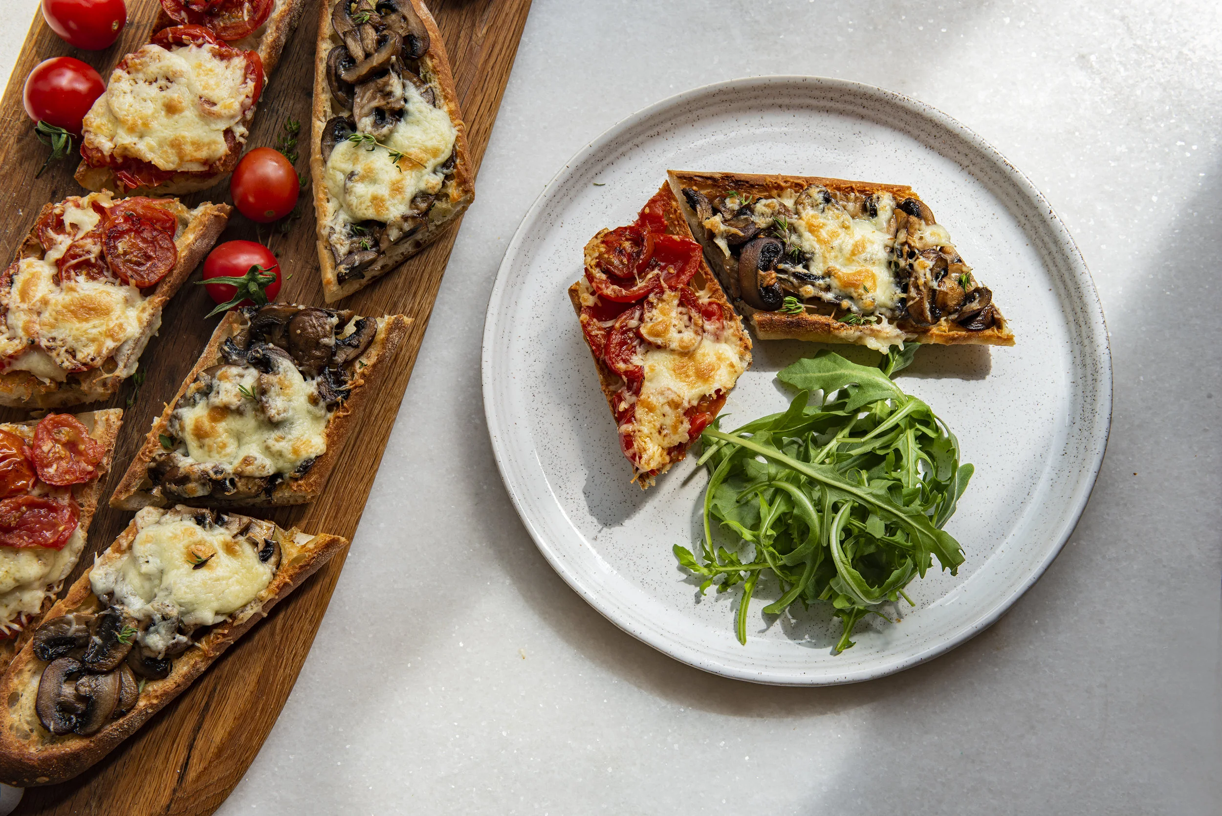Portion of toasted baguette with mushrooms and tomatoes served on plate
