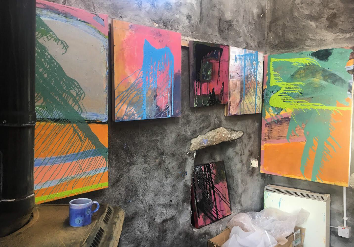 6 ‘poured paint’ pieces on board and canvas on the drying wall of Liz’s studio. All 6 are now at Mark Borghi Fine Art in Palm Beach, Florida.