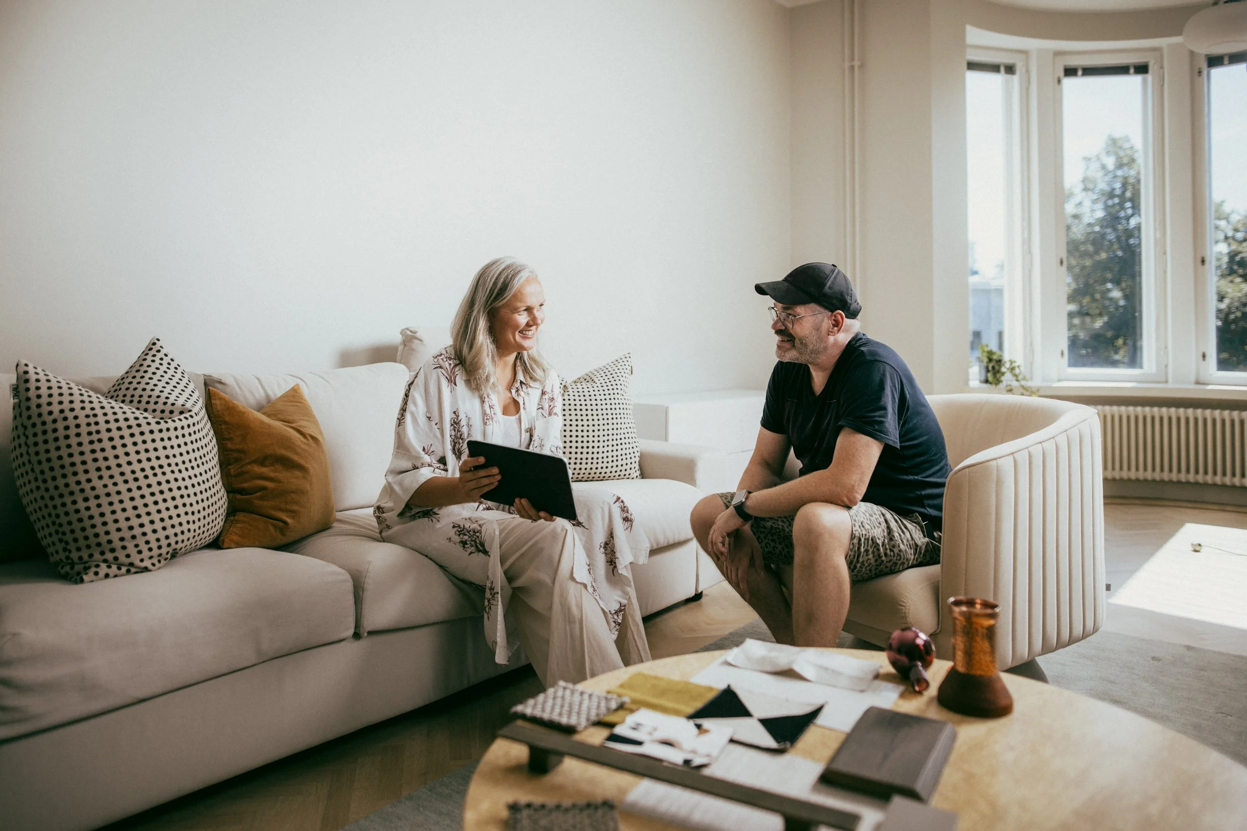 Siru Tuomisto discussing an interior design project with a client in a light-filled Helsinki residence.