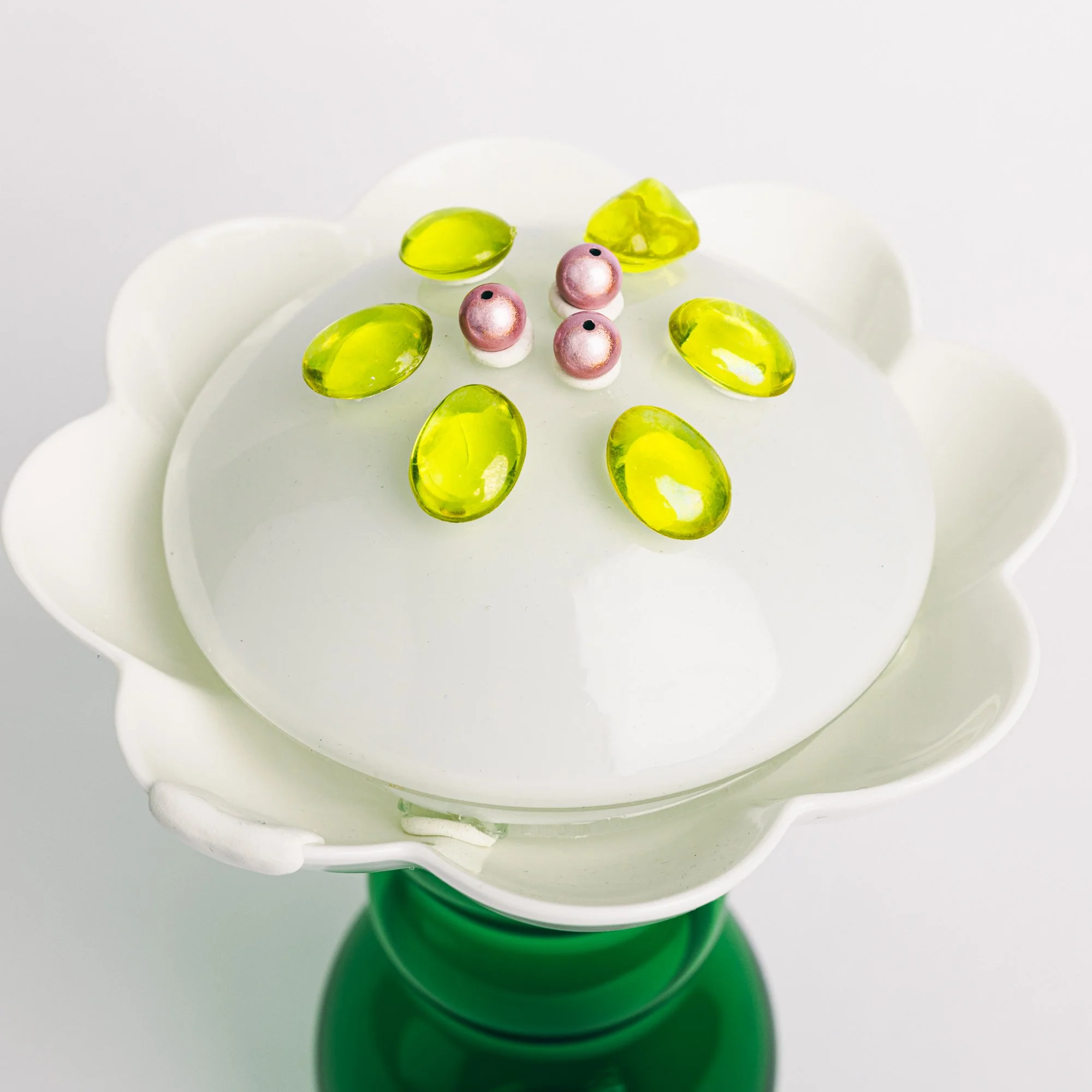 Second Chance Art is made from existing materials- Late Bloomer Flower decorated with yellow gel-like stones and pink pearl-like beads on top.