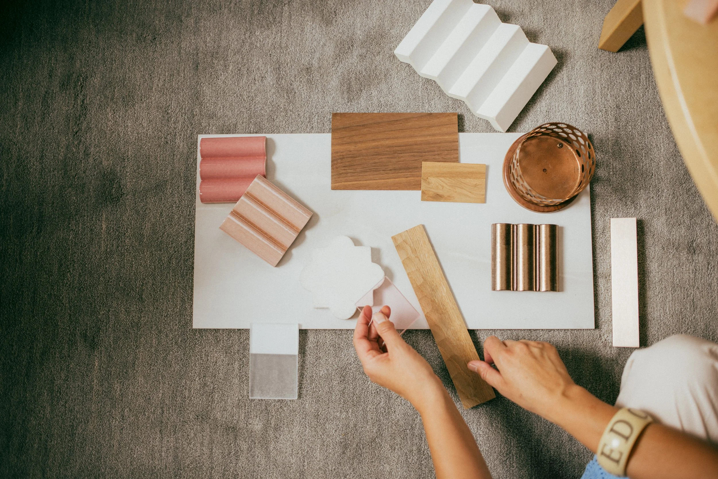 Interior design material selection with wood, tile and metal samples for a Studio Siru residential renovation project.