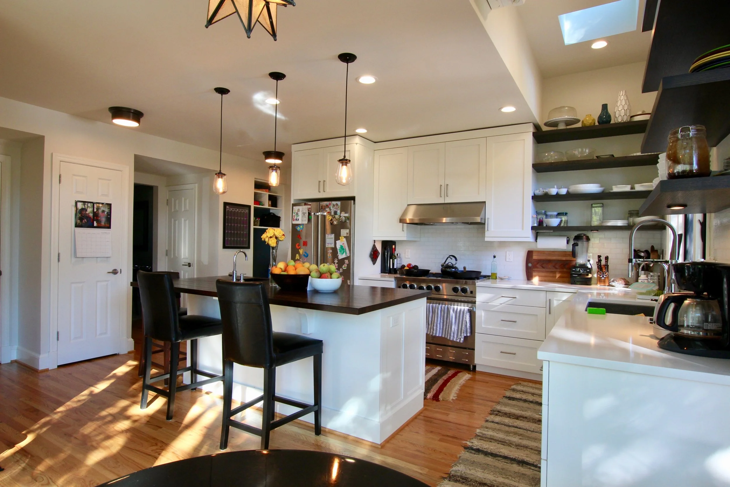 A new vertical addition off the back of a 1940’s square brick house was designed to transform the main floor with a new kitchen and mudroom, and access to outside from the living room. The breakfast room opens to the rear yard with a corner wall of glass. The addition creates space for a laundry room on the second floor and a new master suite, with rear balcony on the third floor.
