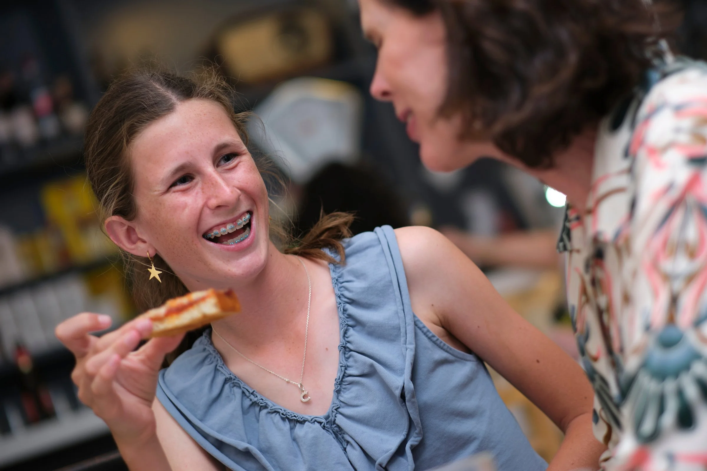 A teenager enjoys a tosta with her mom on Walk and Eat's family tapas tour in Madrid.