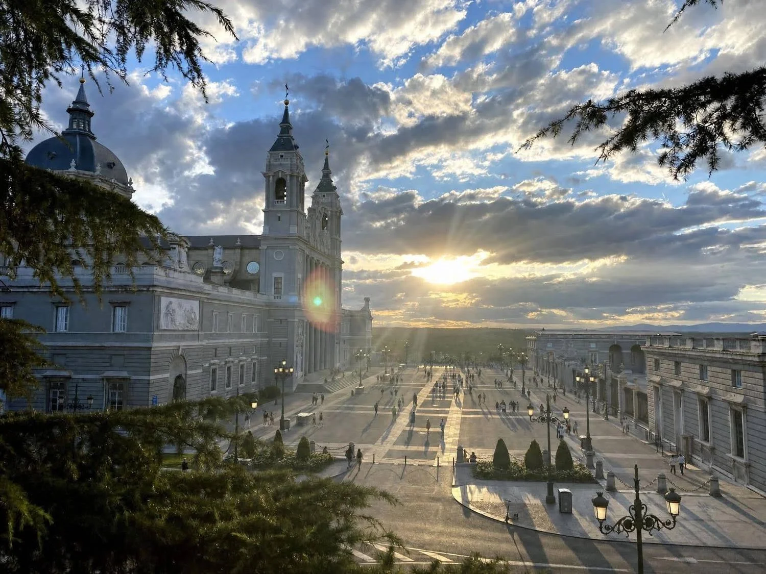 The sun sets behind Madrid's Cathedral and Royal Palace.