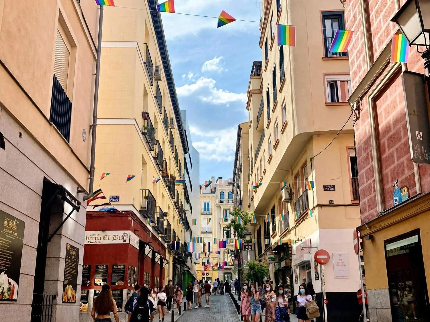 Rainbow flags hang over a beautiful street in Madrid's Malasaña neighborhood.