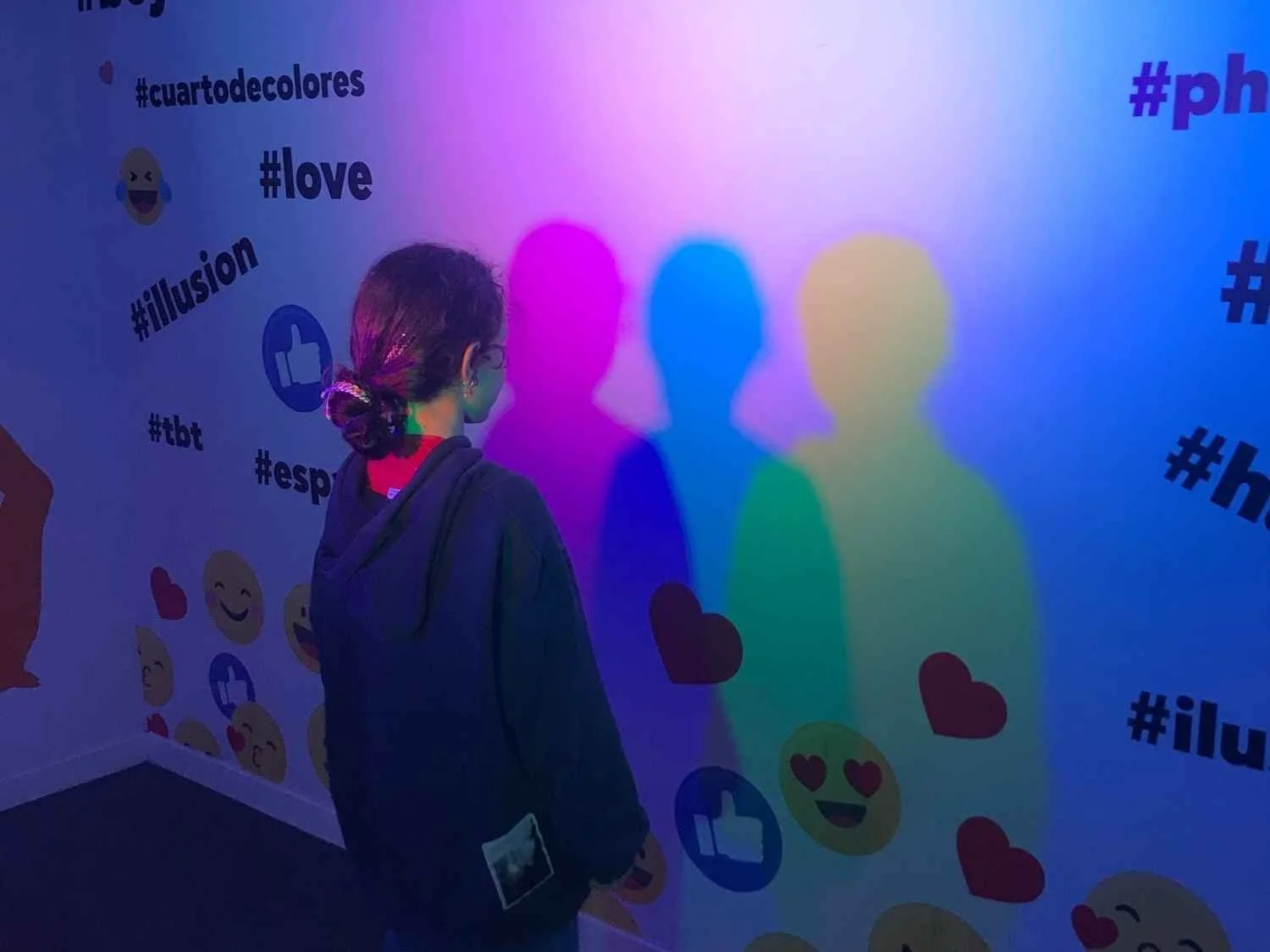 A young girl admires her multi-colored reflection at the Mercado de Ilusiones in Madrid.