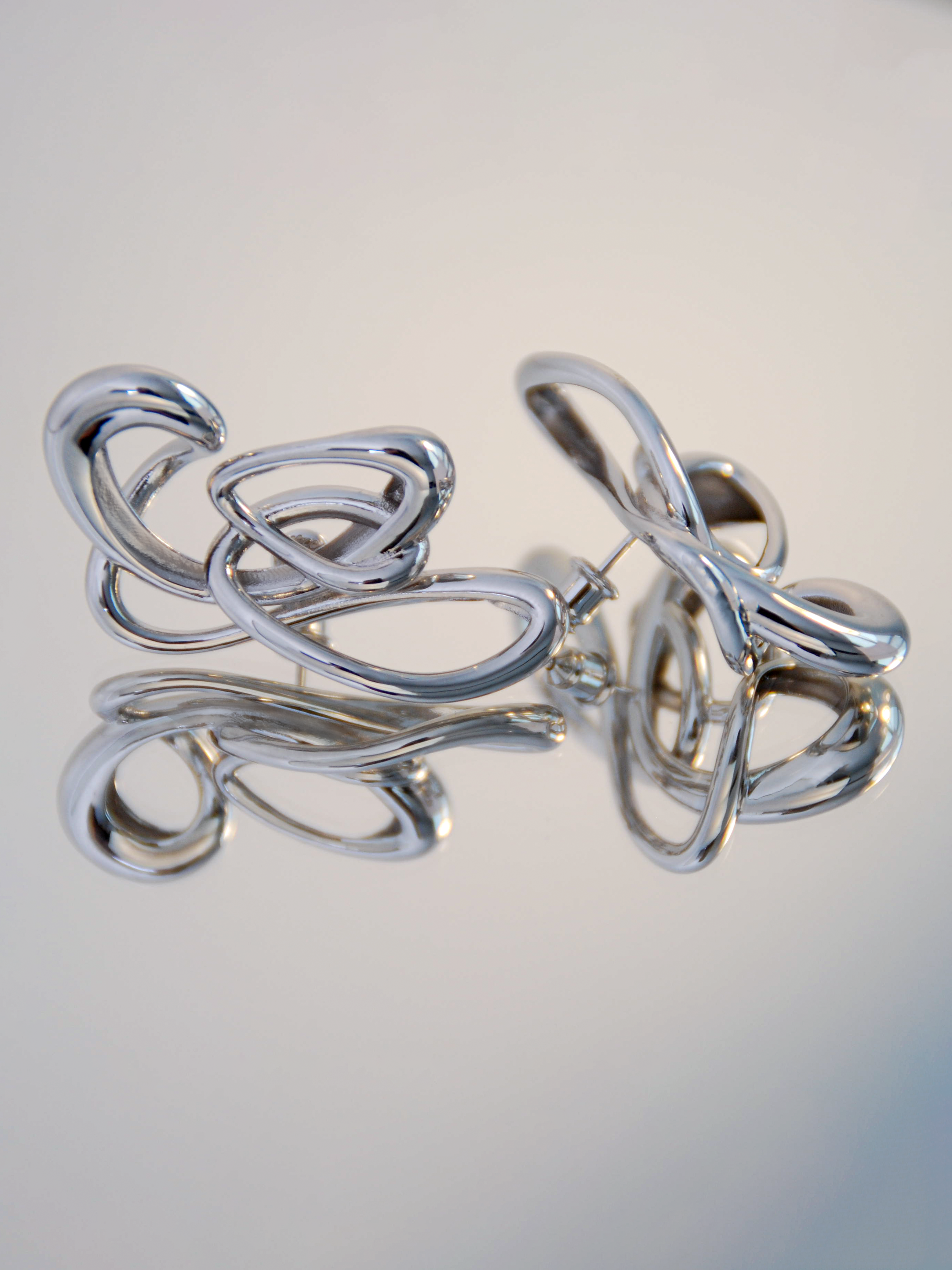 nood_FlickerEarrings_2025_RhodiumPlatedBrass_2.5x5cm_£63.png