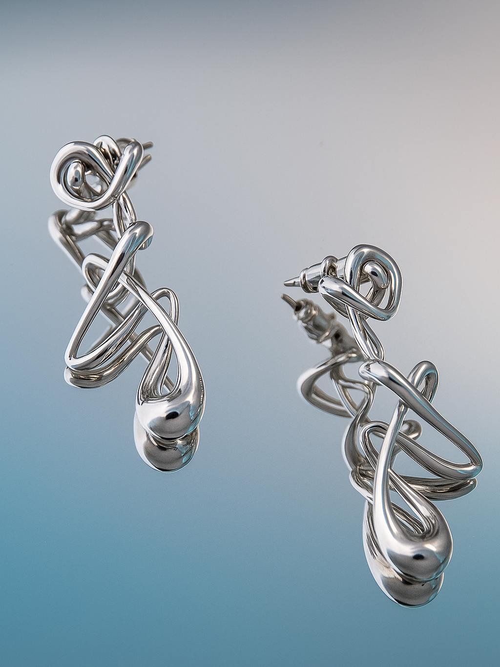 nood_Caligraphy_2025_RhodiumPlatedBrass_2x5cm_£52.png