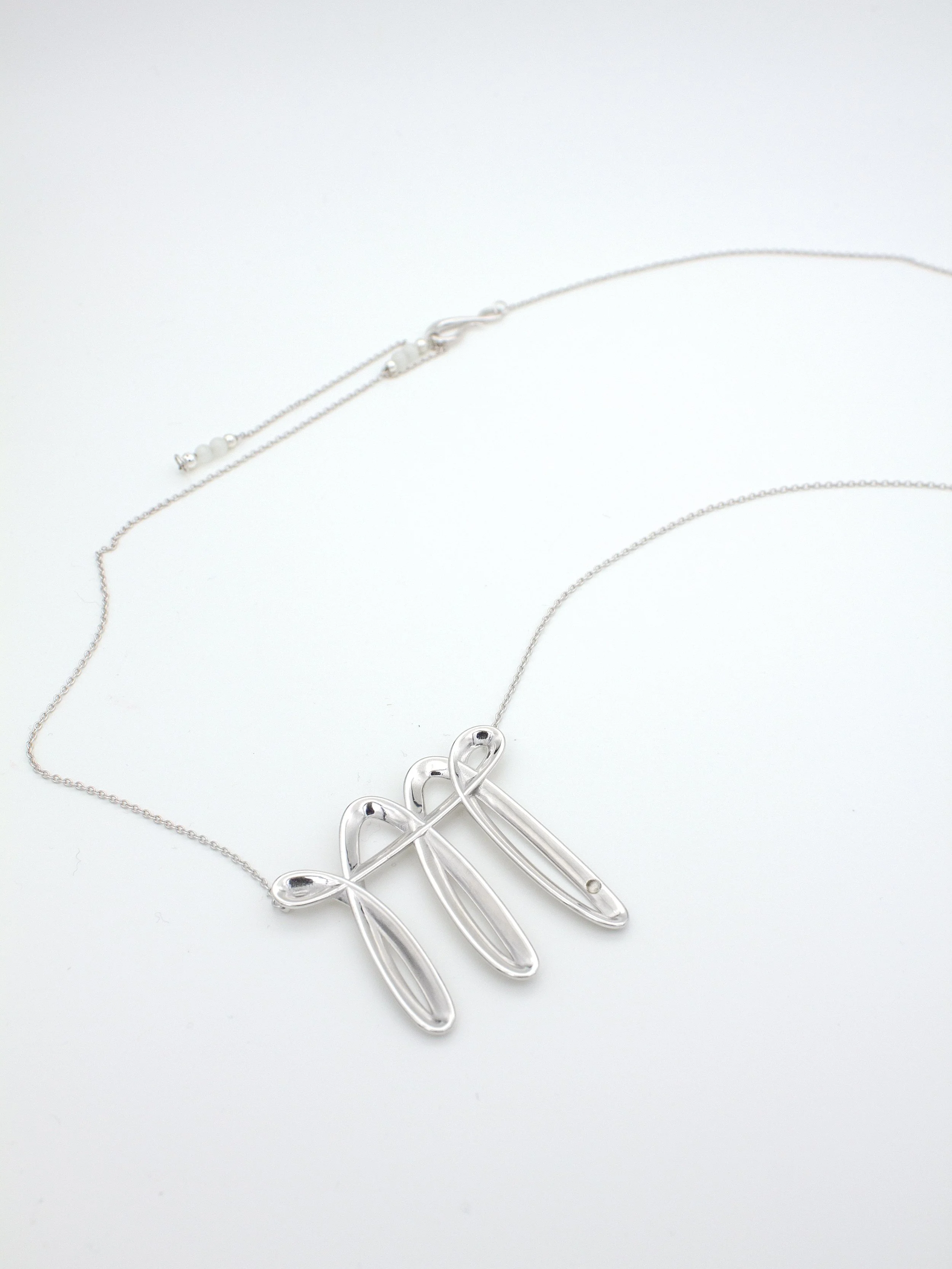 nood_LuckyStroke_2025_RhodiumPlatedBrassWithCat’sEyeStone_85cm_£80.jpg