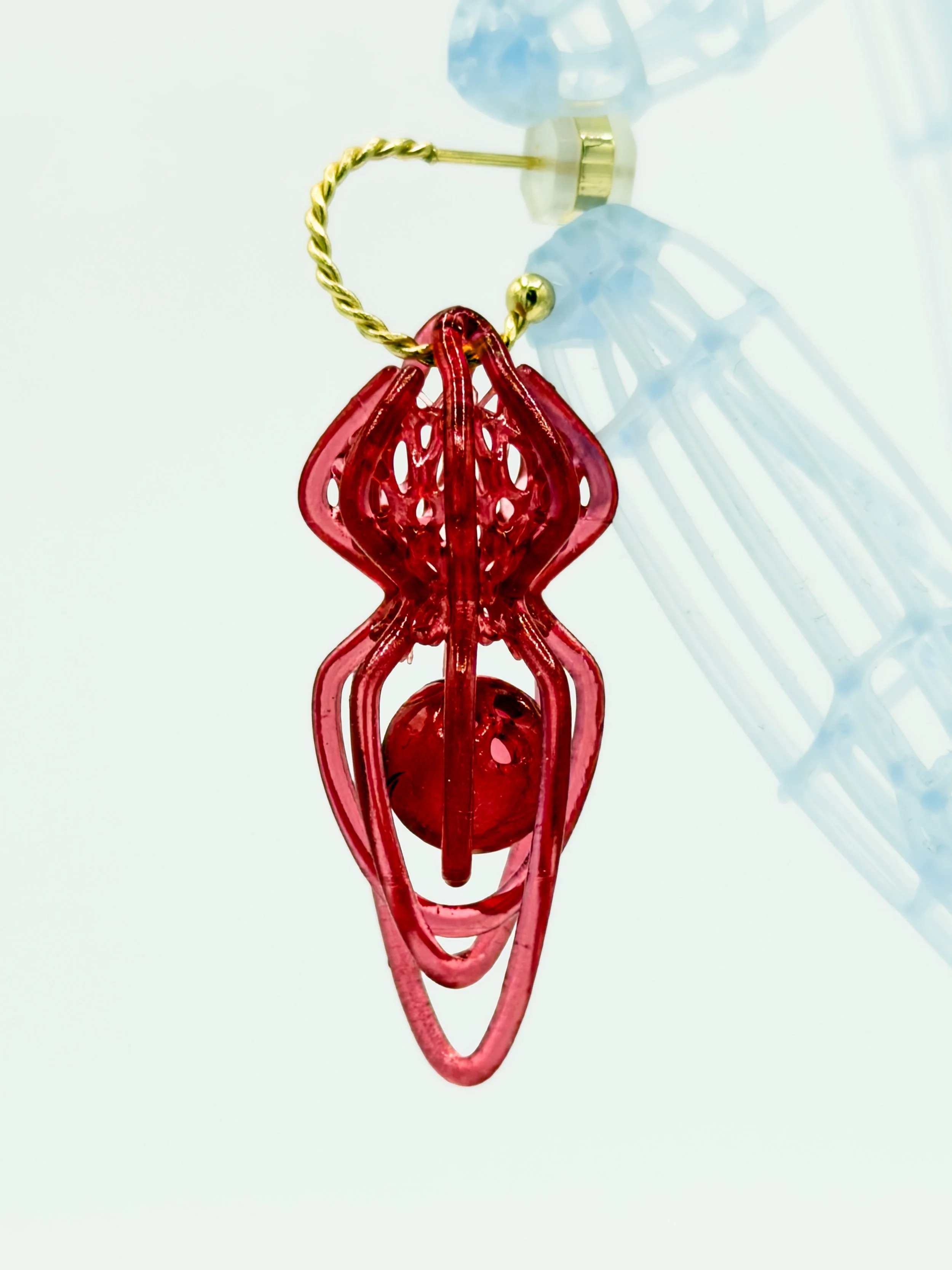 FernandaPovoa_AnemonaeLucida_red1_2023_Plant-PlantBasedResinLacquer18kGoldPlated304StainlessSteelHoops_6x2x2cm_£100.jpg