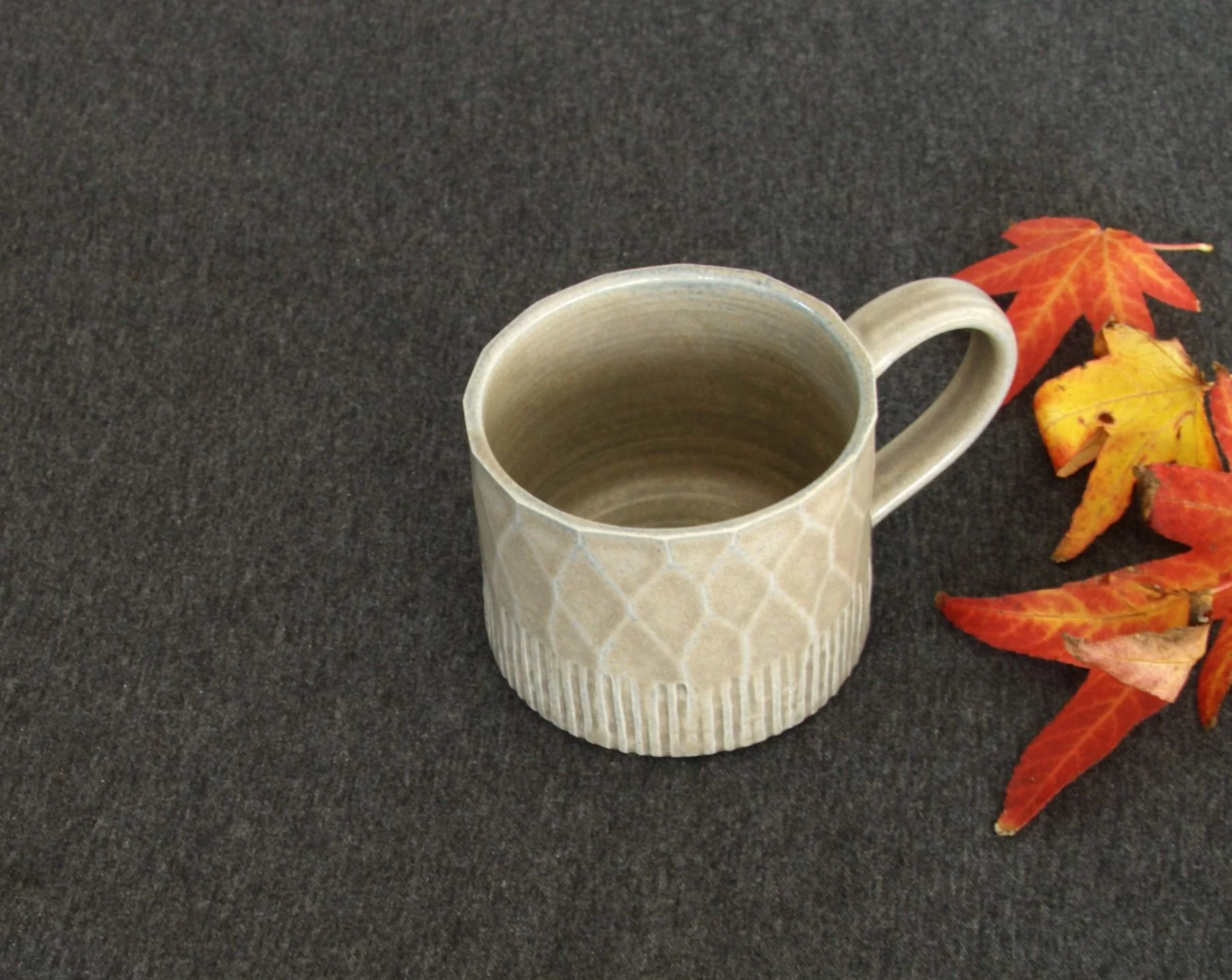 Blue Grey facetted glaze test mug Autumn.jpg