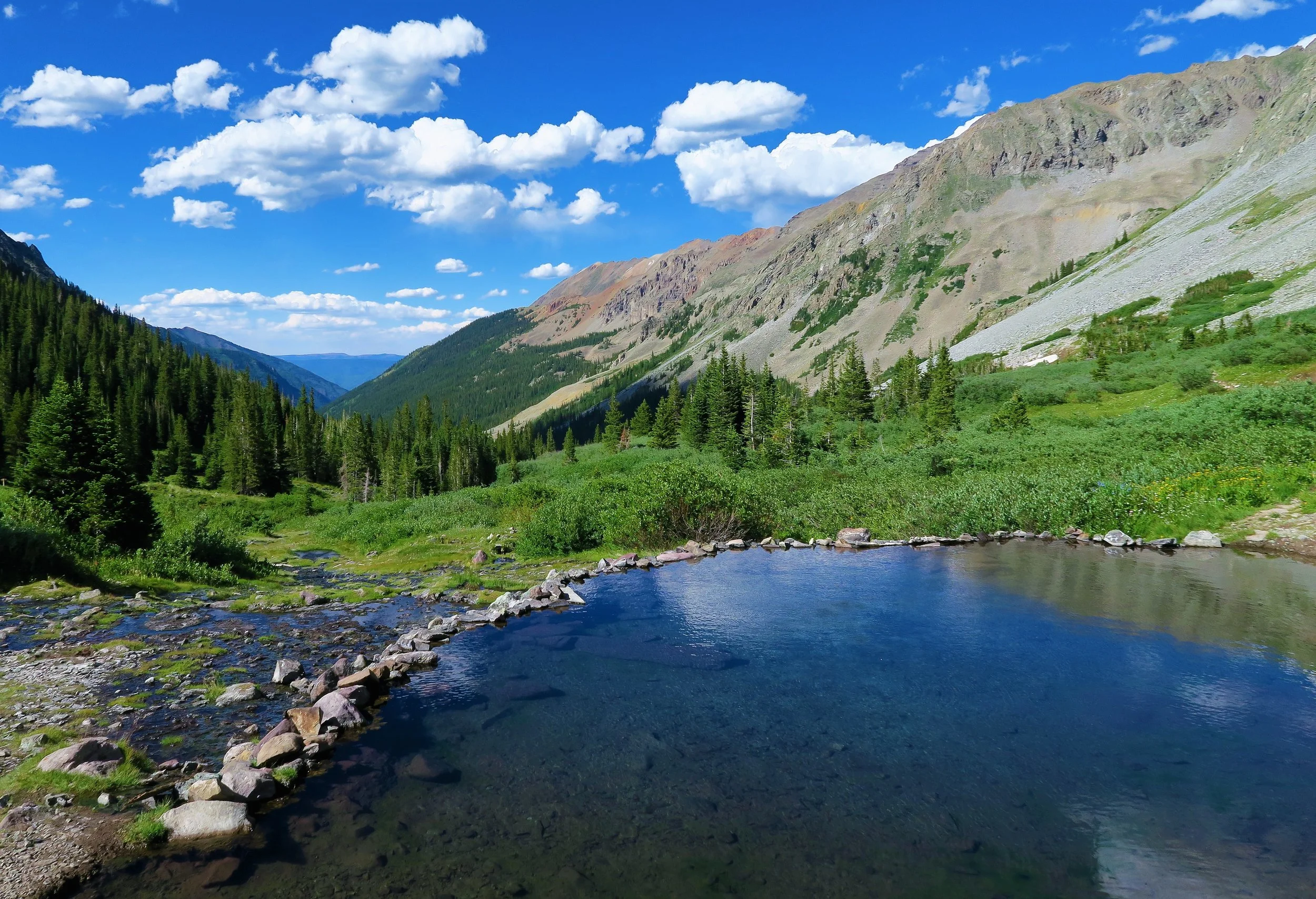 The Conundrum Hot Springs area has seen a spike of increased visitation in recent years leading to trampling of fragile alpine vegetation, an excess of fecal matter, and an altered visitor experience. Tyler Lee worked to create a permitting system to protect this unique area.