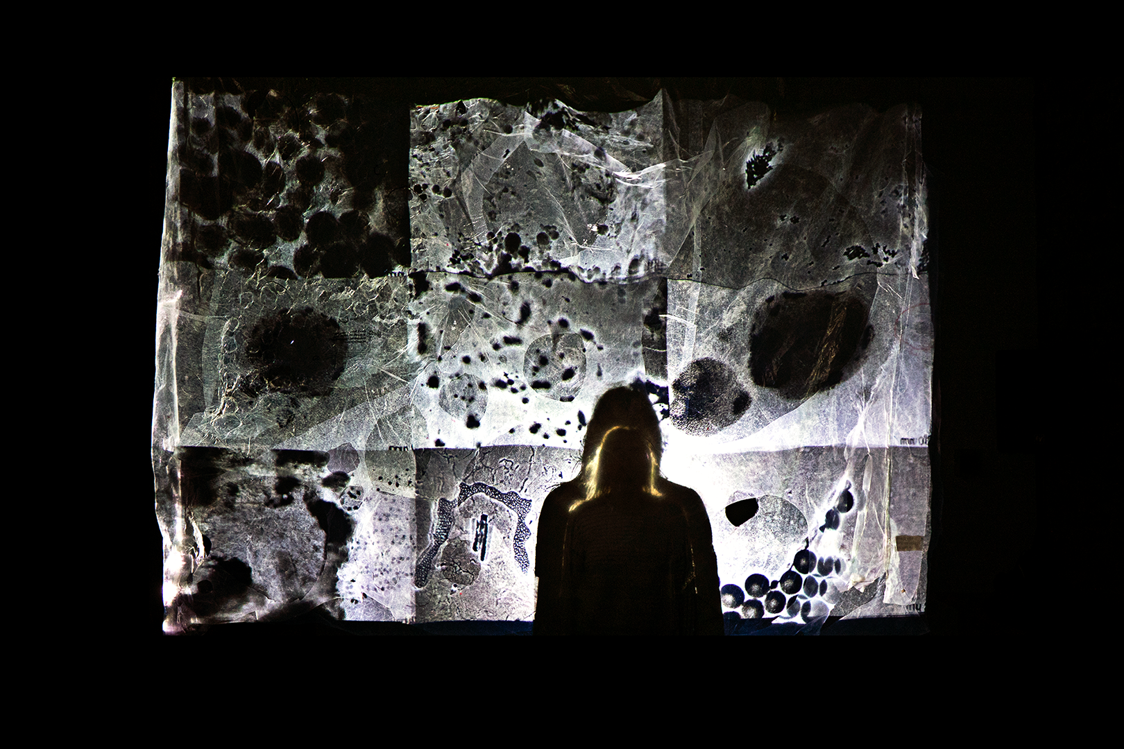  Material Investigation for Plastic Magnitudes. 2023. Installation shot. 10' x 12' x 3'.  Digital media of JRC research on microplastics and nanoplastics projection mapped onto community-collected sheet plastic. 