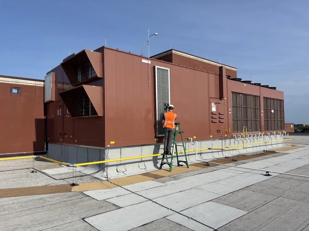 HVAC testing and balancing technician inspecting a commercial rooftop HVAC system at a school to improve indoor air quality and occupant comfort.