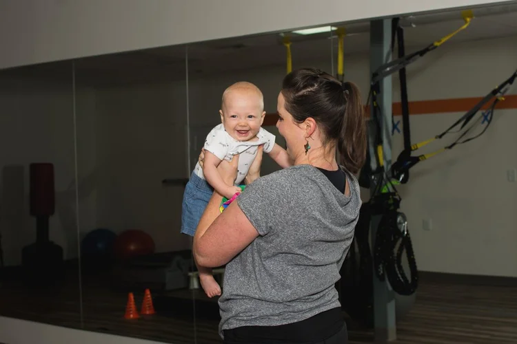 A mom lifting her baby during a session