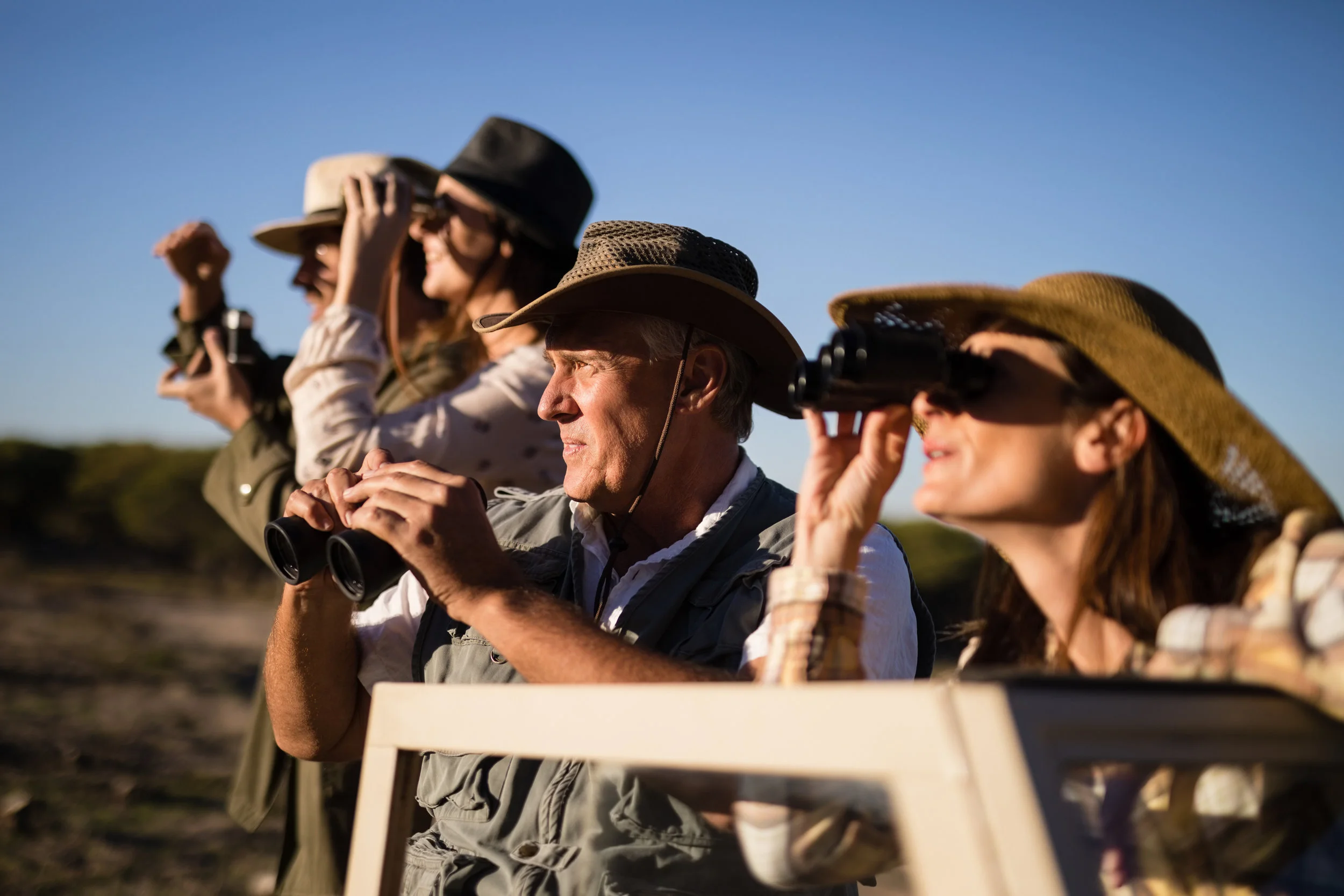 Friends-looking-through-binoculars-during-safari-vacation-879922462_3869x2579.jpeg