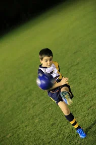 Littlie kicking ball fast blurry.jpg