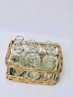 Small Vintage Bottles in a Whicker Basket