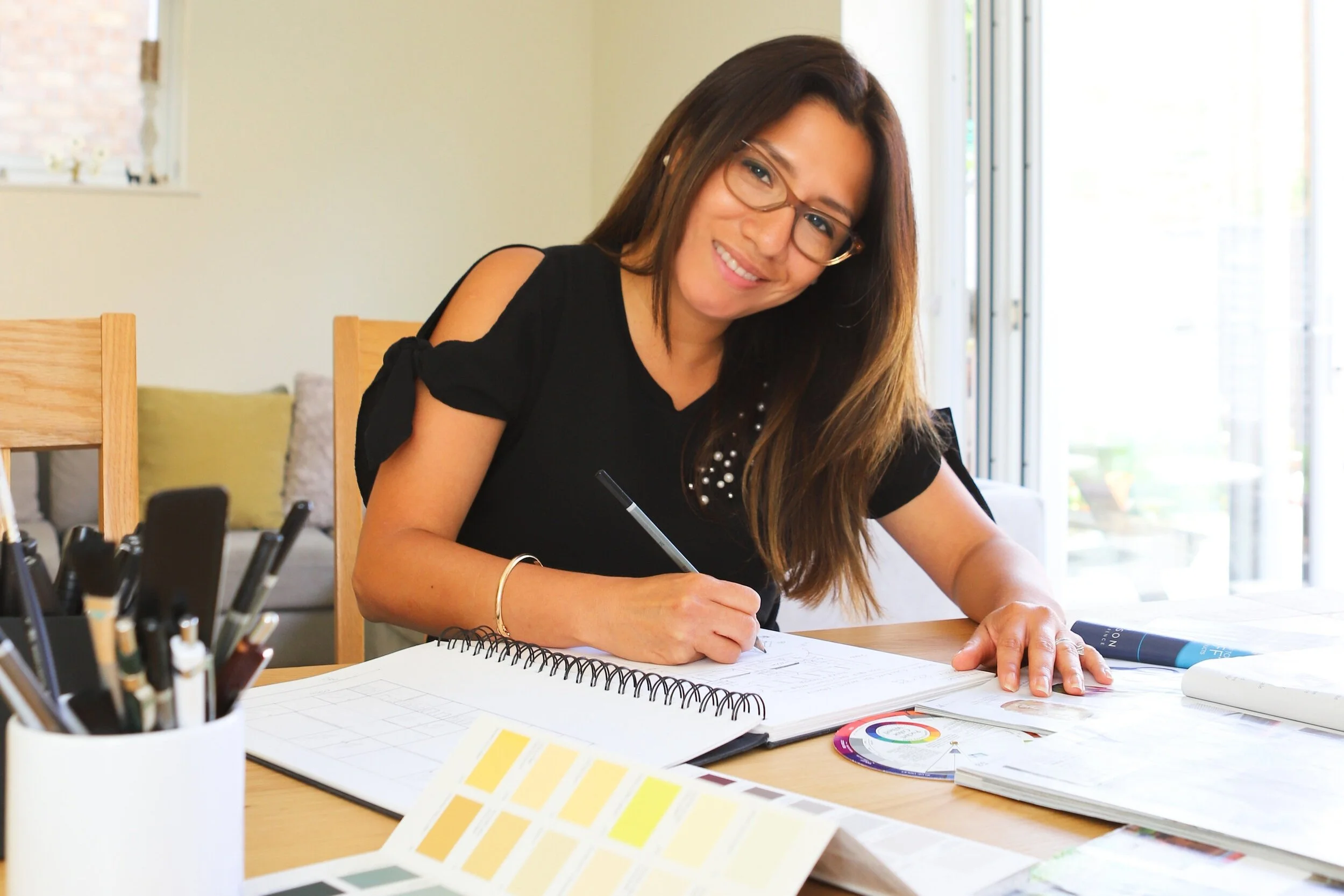 Lucia working on a branding project at her desk