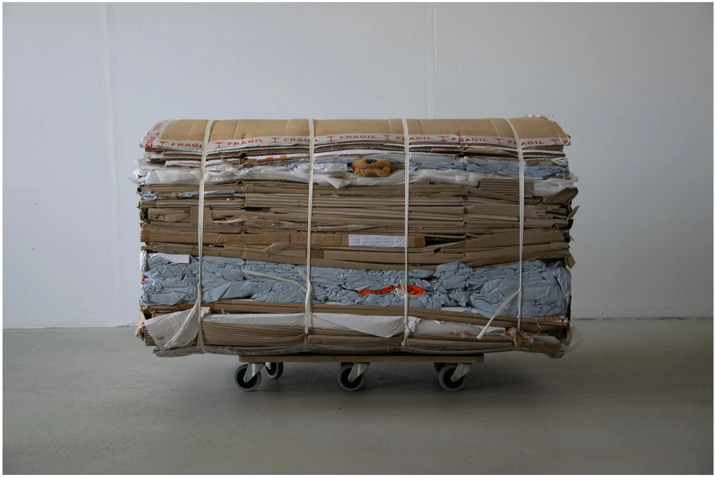 Untitled,  pressed cardboard, teddy bear and wheels, 78 cm x 110 cm x 70 cm. 2019