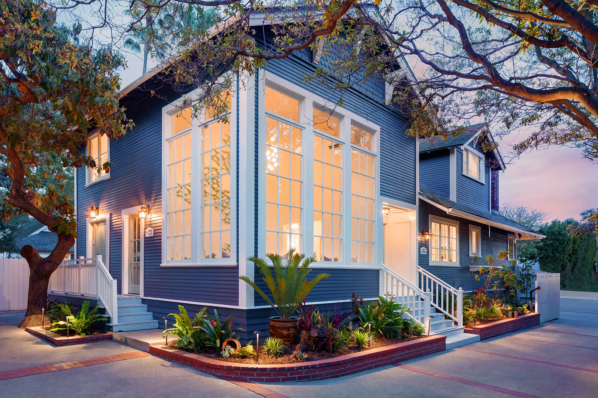 Exterior shot front of Hideaway with large windows and plants 