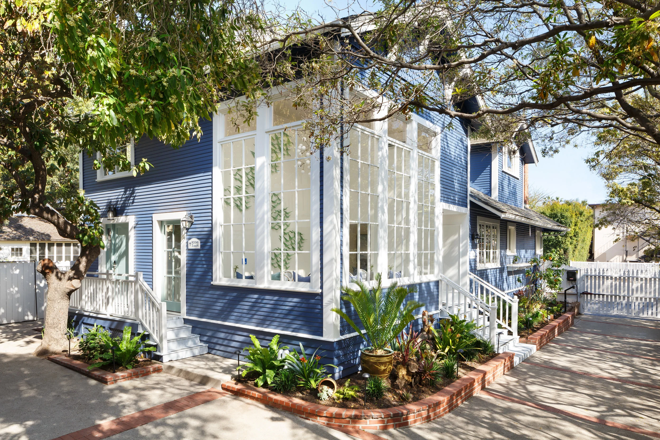 exterior wide view corner of hideaway with large windows and steps 