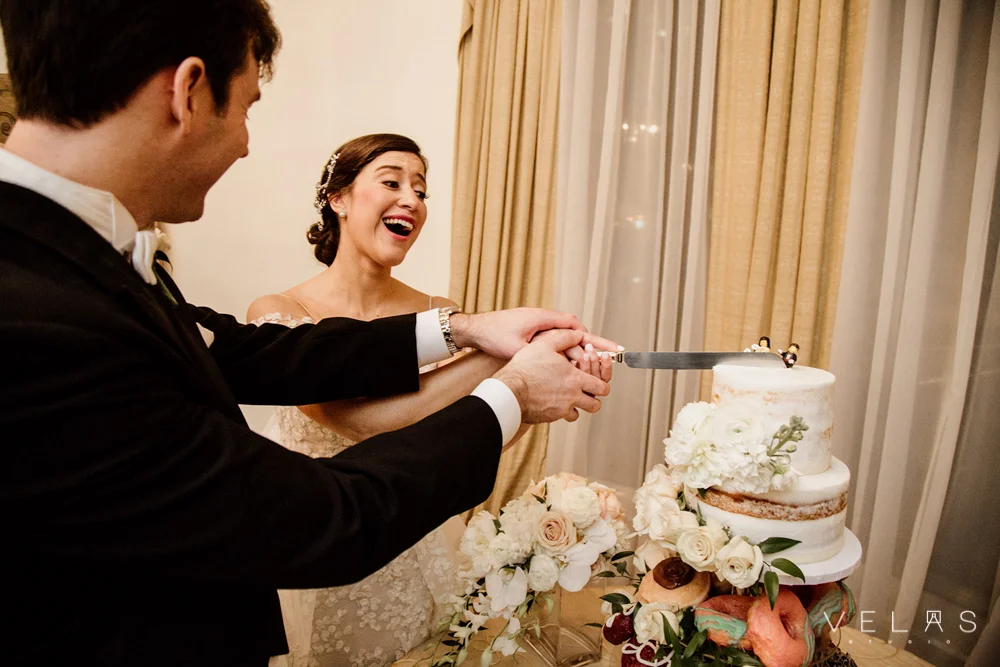 Bride and groom cut the cake at The Wimbish House.