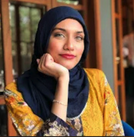 Fareeha Ahmad in a yellow tunic and dark blue hijab.