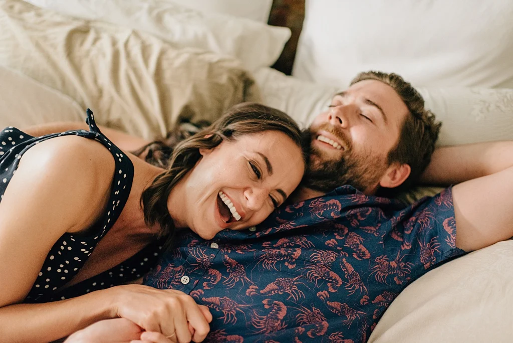 couple-laughing-on-bed