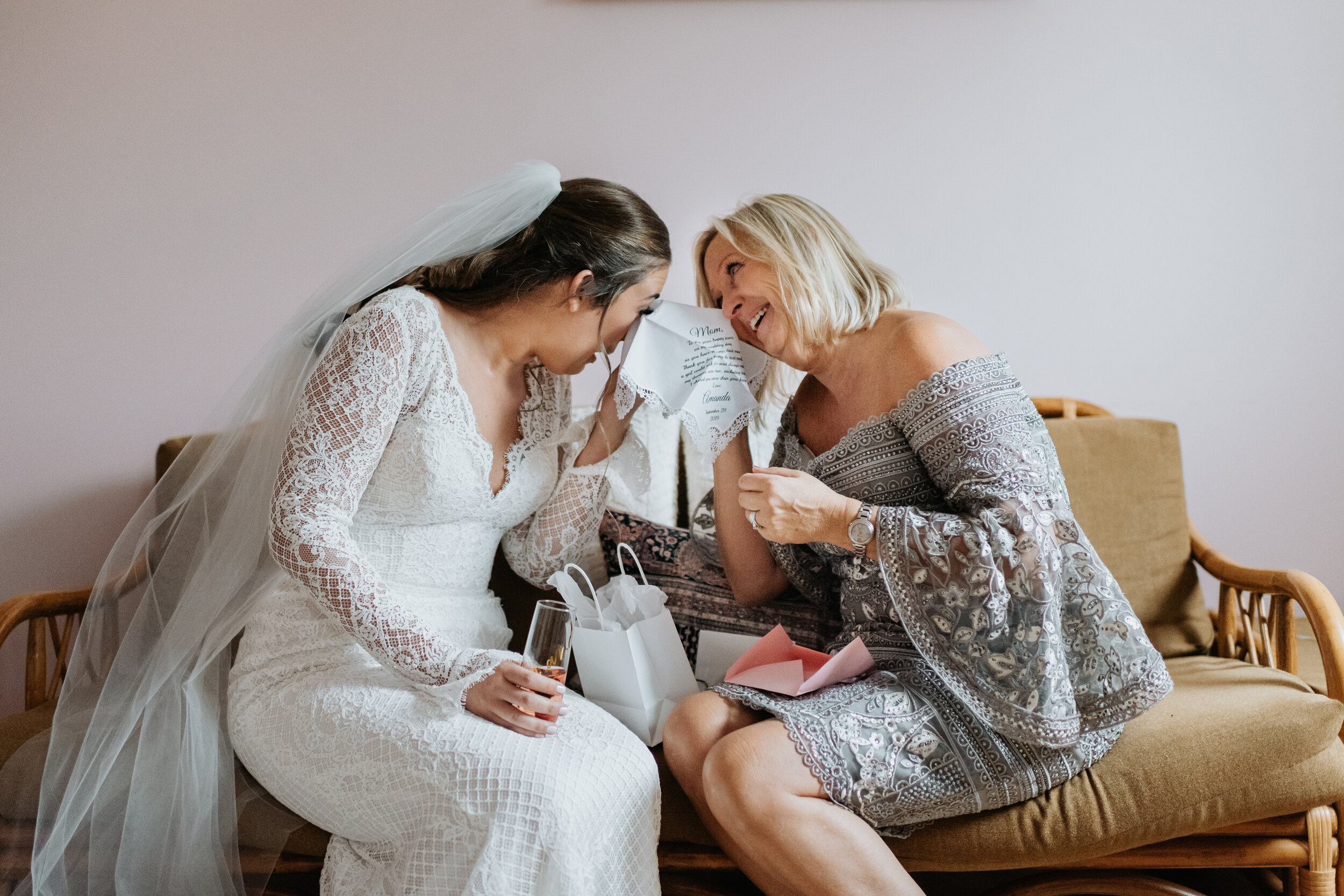 Mother and bride sharing a handkerchief.