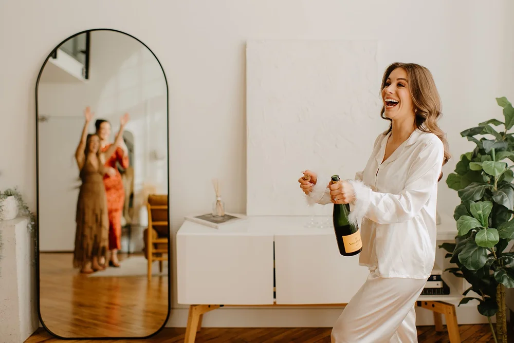 STORYS Building Wedding in Toronto Robyn and Tyler –  Bride popping champagne