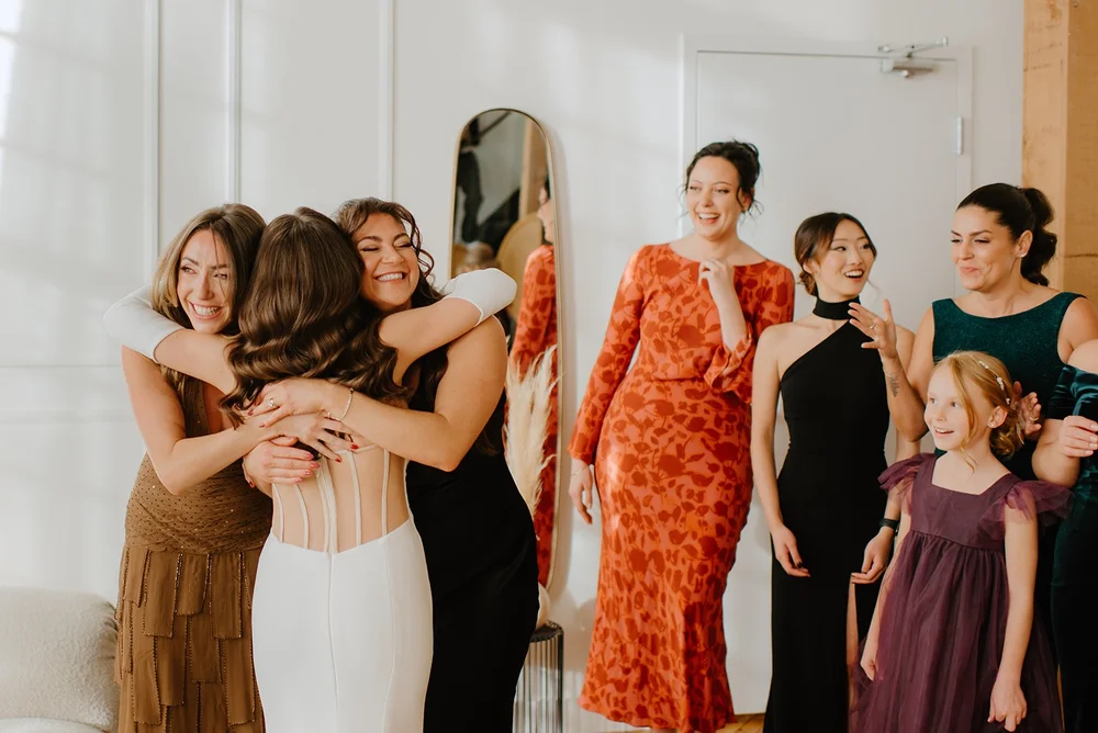 STORYS Building Wedding in Toronto Robyn and Tyler –  Bride hugging bridesmaid in a sweet moment