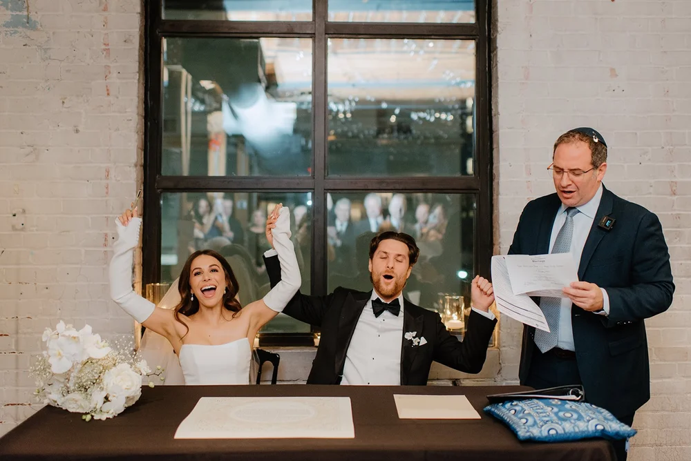 STORYS Building Wedding in Toronto Robyn and Tyler – Couple cheering joyfully after signing their marriage license