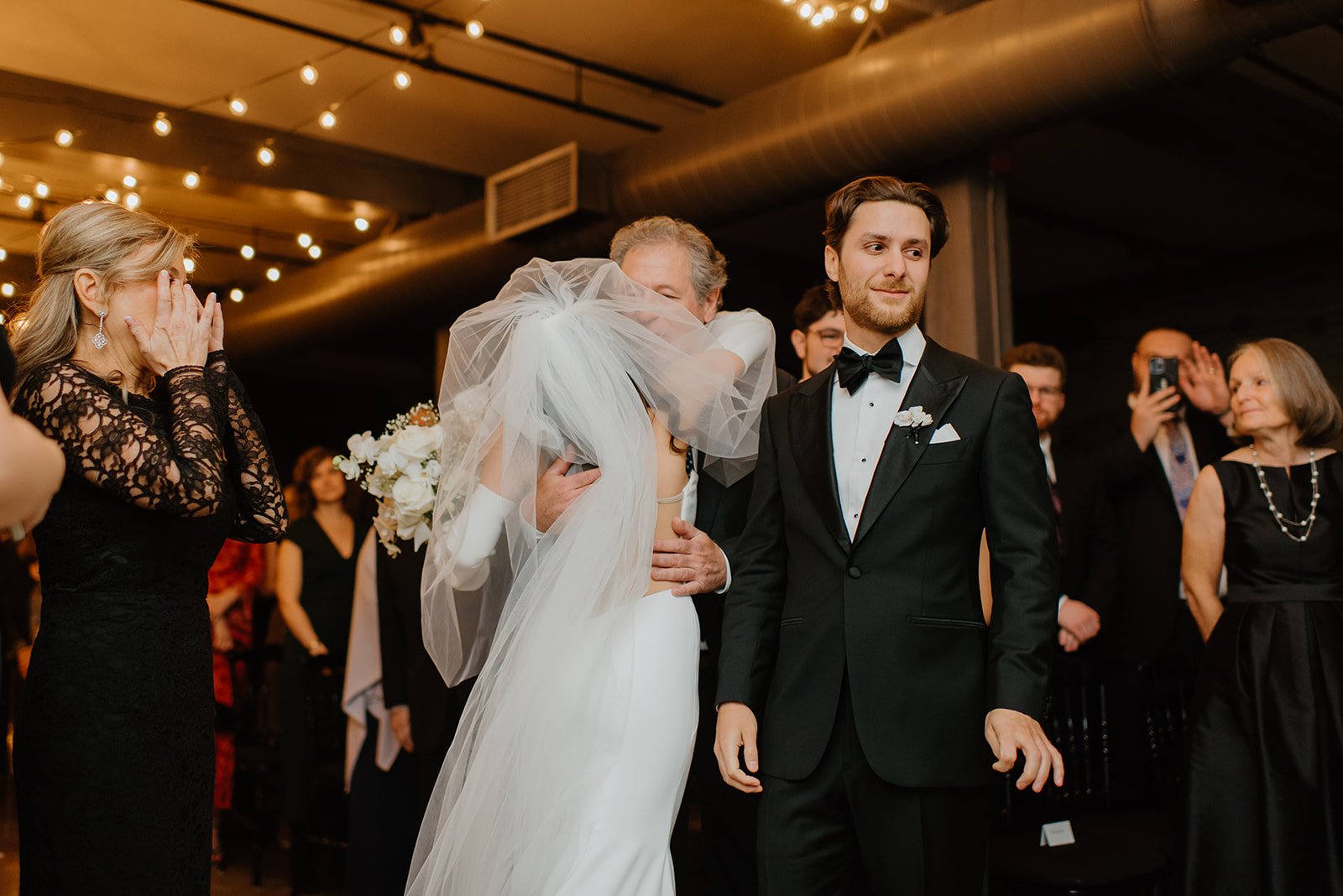 STORYS Building Wedding in Toronto Robyn and Tyler – Bride and groom walking together down the aisle
