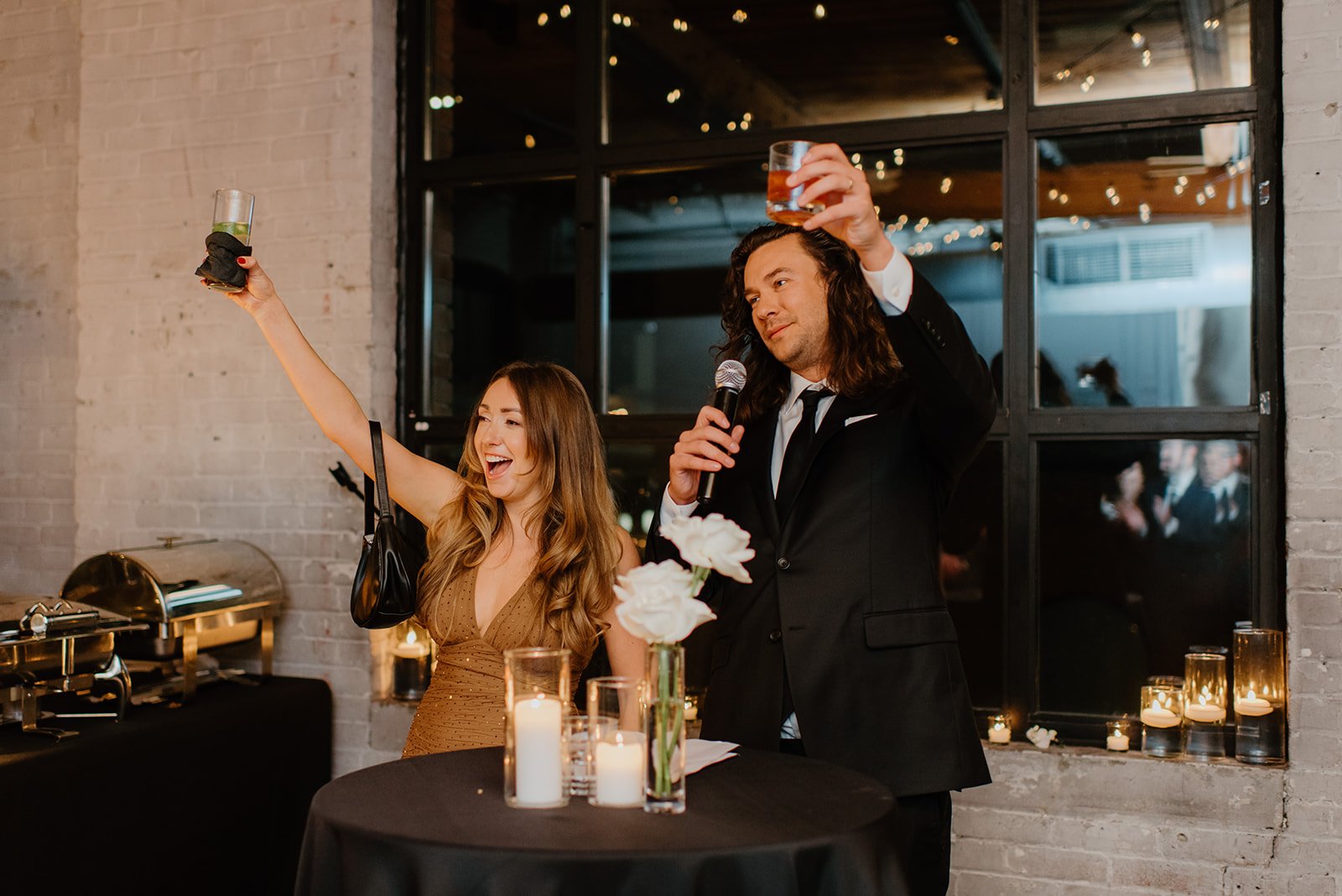 STORYS Building Wedding in Toronto Robyn and Tyler – Wedding guests cheering and raising glasses in celebration