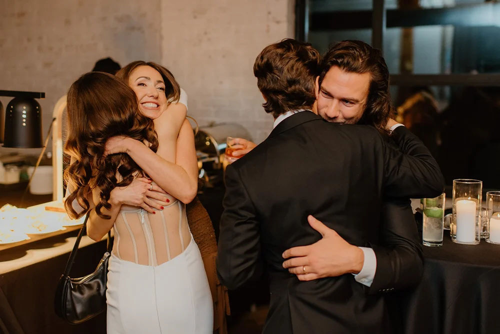 STORYS Building Wedding in Toronto Robyn and Tyler – Bride and groom hugging wedding guests during the reception