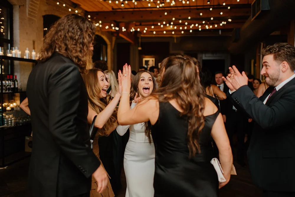 STORYS Building Wedding in Toronto Robyn and Tyler – Bride happily entertaining and engaging with guests during the reception