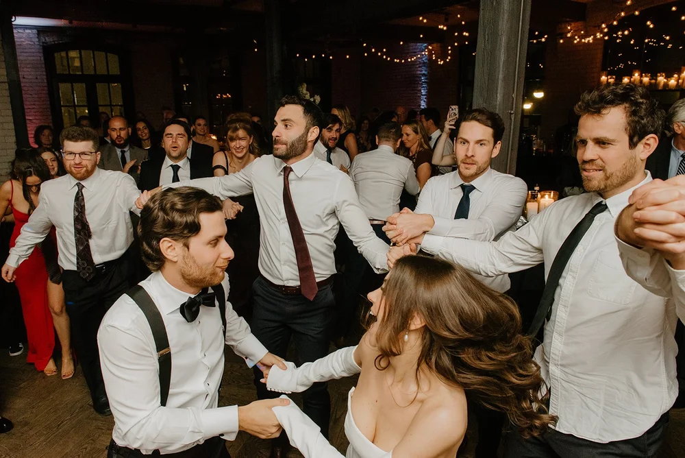 STORYS Building Wedding in Toronto Robyn and Tyler – Bride and groom dancing lively, filled with joy and energy