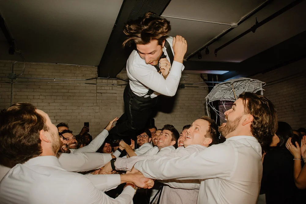 STORYS Building Wedding in Toronto Robyn and Tyler – Groom Sharing a Fun Dance with His Groomsmen
