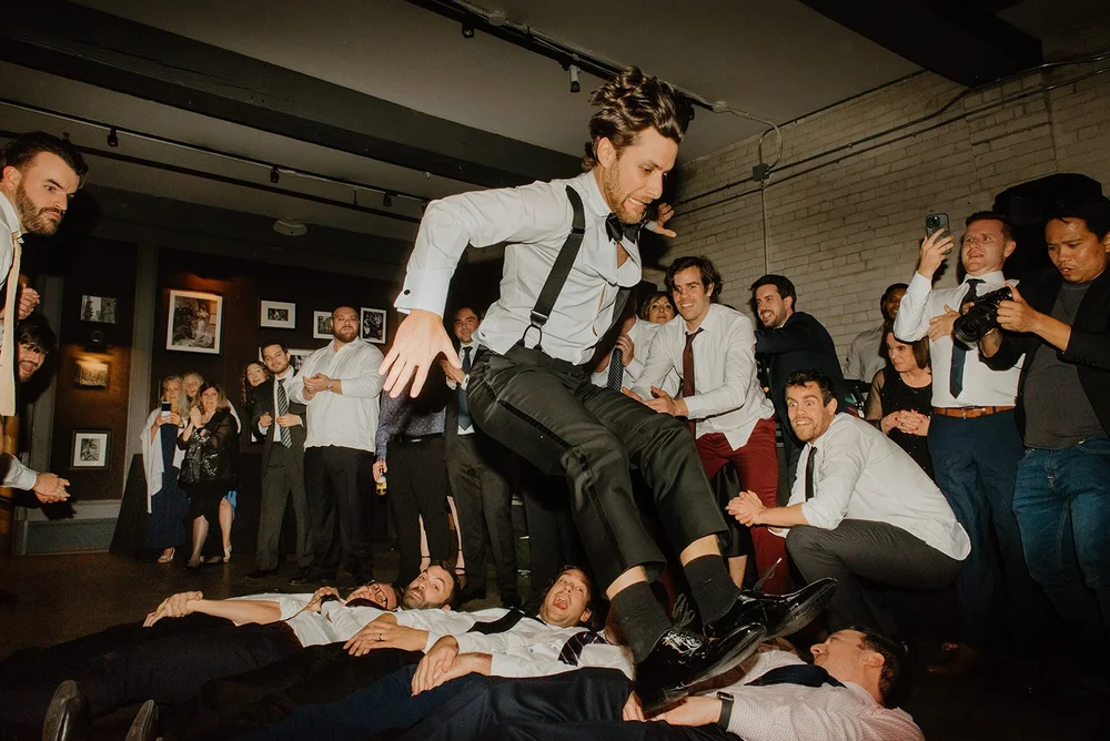STORYS Building Wedding in Toronto Robyn and Tyler – Groom Dancing and Enjoying the Moment with His Groomsmen