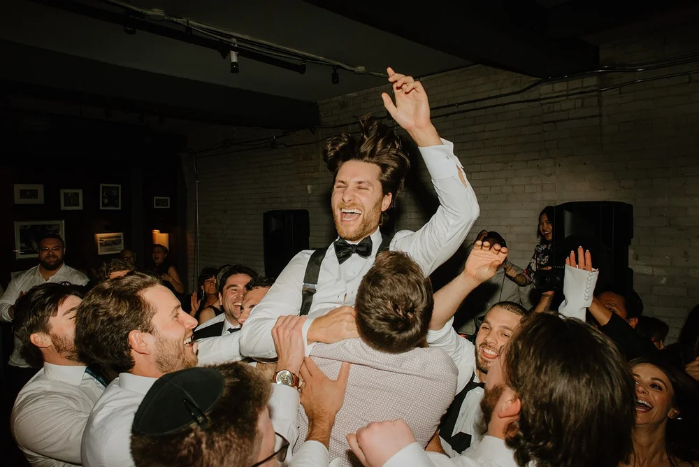 STORYS Building Wedding in Toronto Robyn and Tyler – Groom Sharing a Fun Dance with His Groomsmen